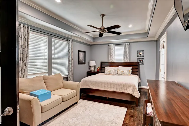 a spacious bedroom with a bed couch and a window