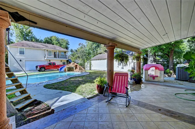 a view of a house with backyard and a slide