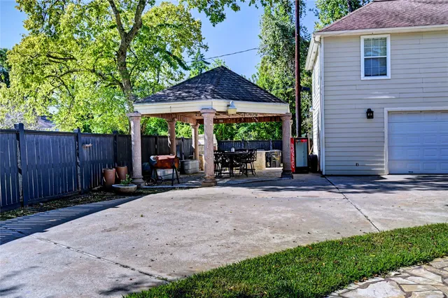 a view of an outdoor dining space with a table and chairs