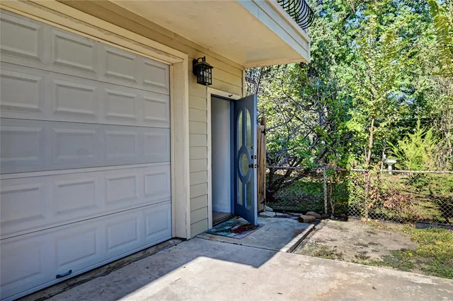 a view of a hallway and a livingroom with furniture