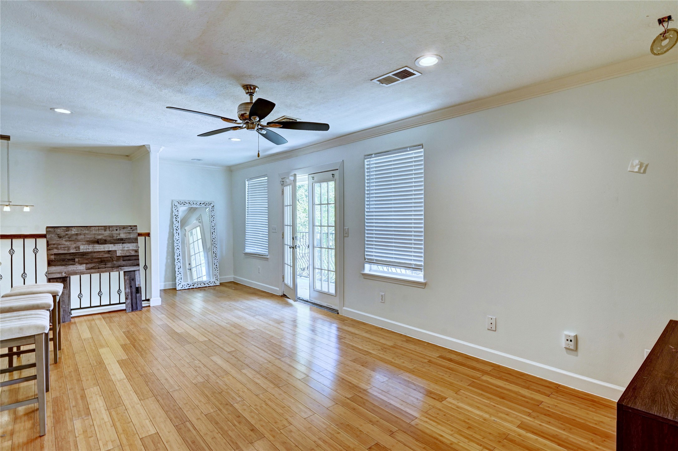 2012 Forest Hill Boulevard Houston, TX 77023 - Photo 46 of 50 a view of a livingroom with wooden floor and a ceiling fan