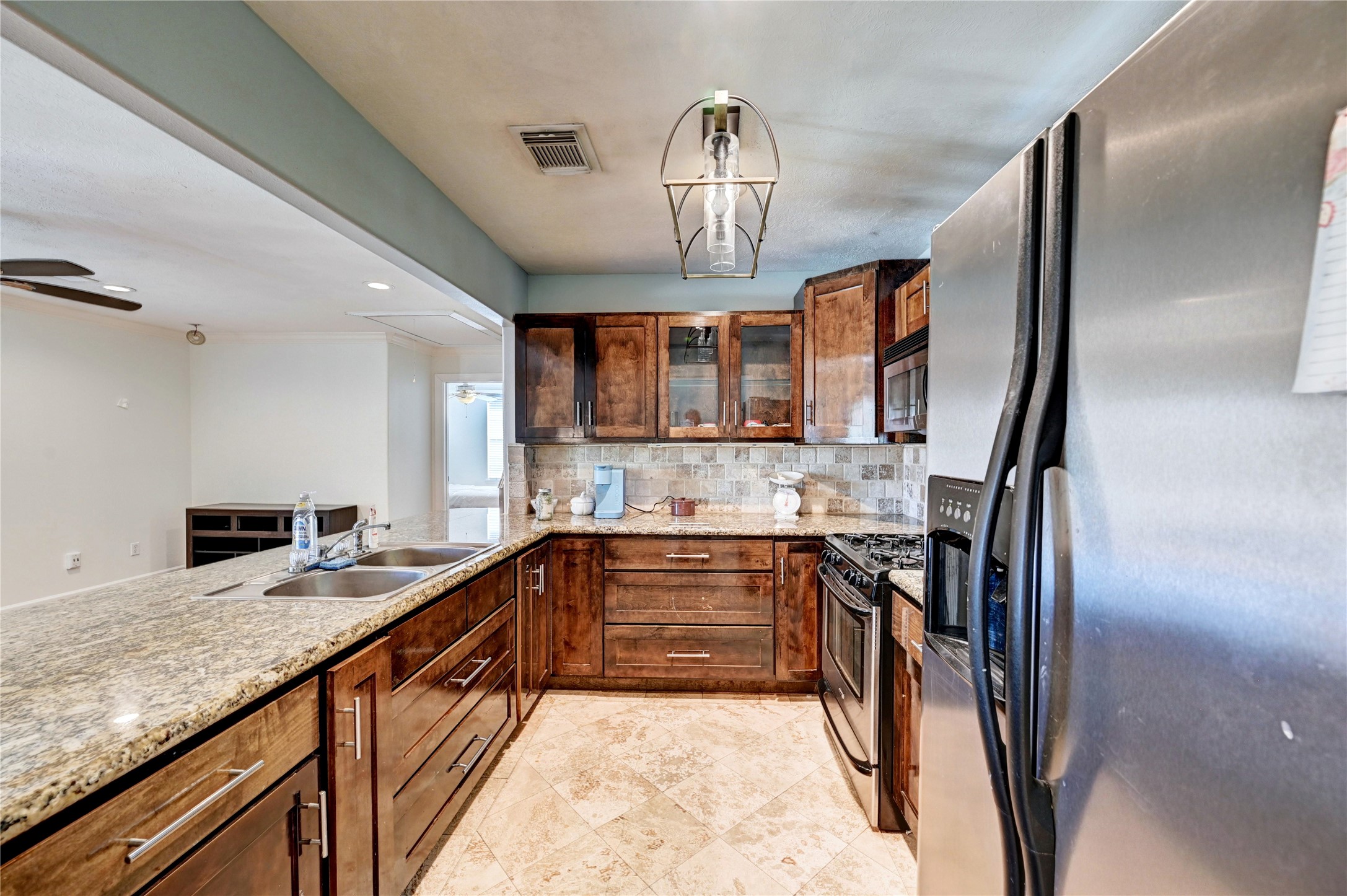 2012 Forest Hill Boulevard Houston, TX 77023 - Photo 47 of 50 a kitchen with stainless steel appliances granite countertop a sink stove and refrigerator