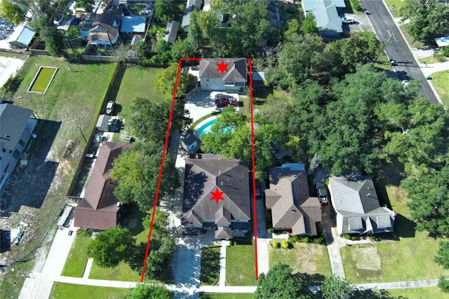 an aerial view of a house with swimming pool and garden view