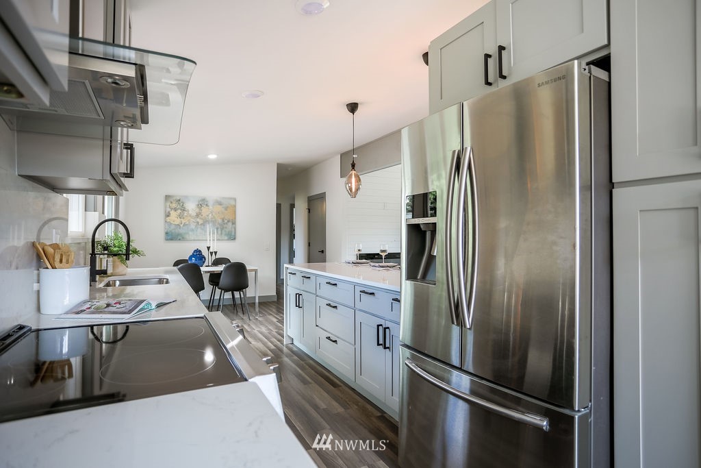 10910 Southeast 181st Street Renton, WA 98055 - Photo 13 of 32 a kitchen with stainless steel appliances a refrigerator sink and stove
