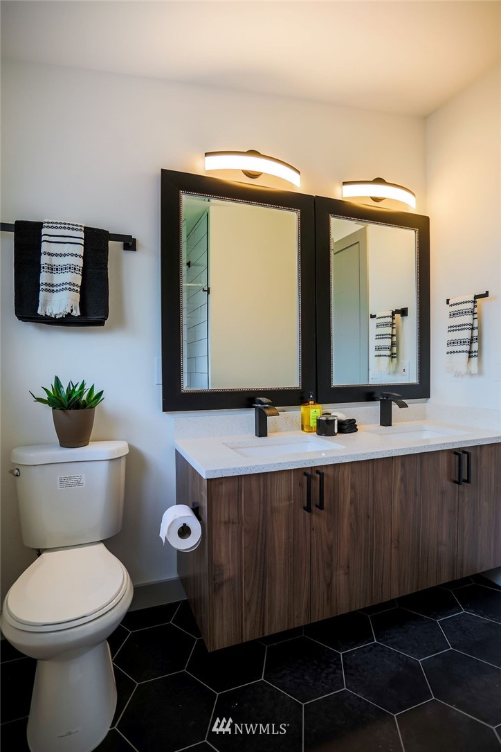 10910 Southeast 181st Street Renton, WA 98055 - Photo 17 of 32 a bathroom with a toilet a sink and mirror