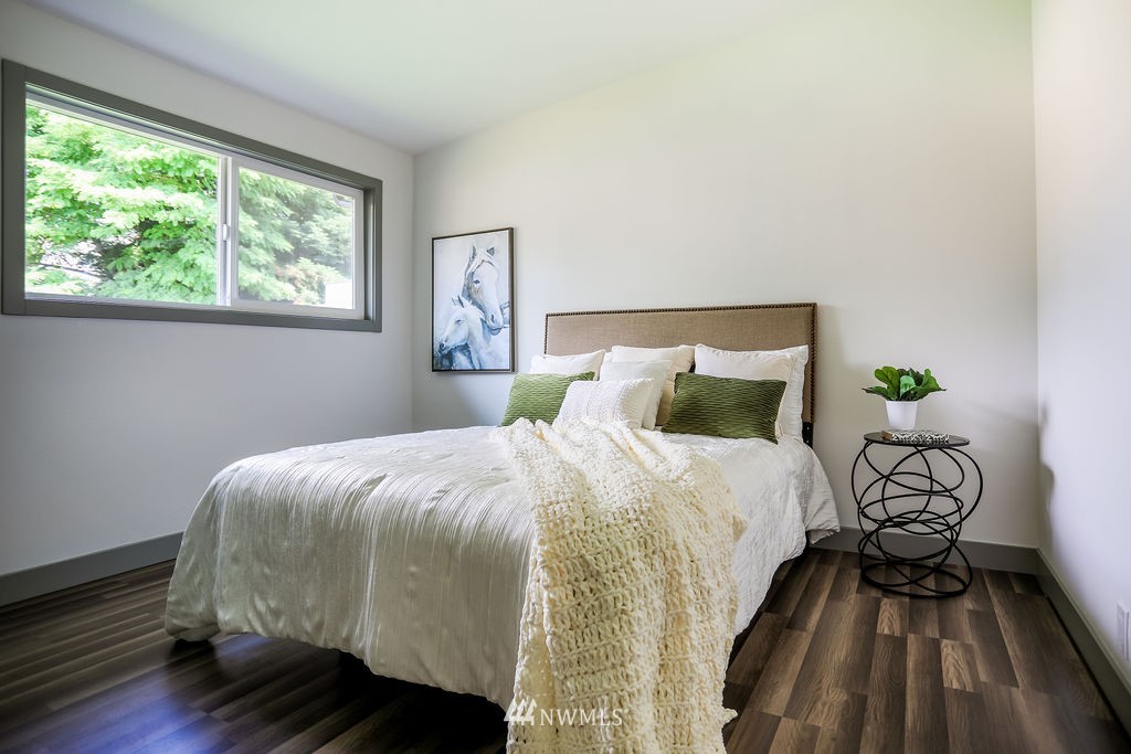 10910 Southeast 181st Street Renton, WA 98055 - Photo 19 of 32 a bed sitting in a bedroom next to a window