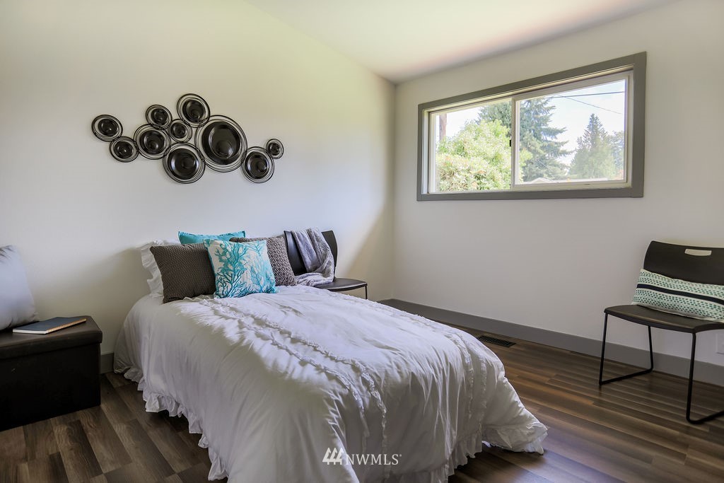 10910 Southeast 181st Street Renton, WA 98055 - Photo 20 of 32 a bedroom with bed and wooden floor