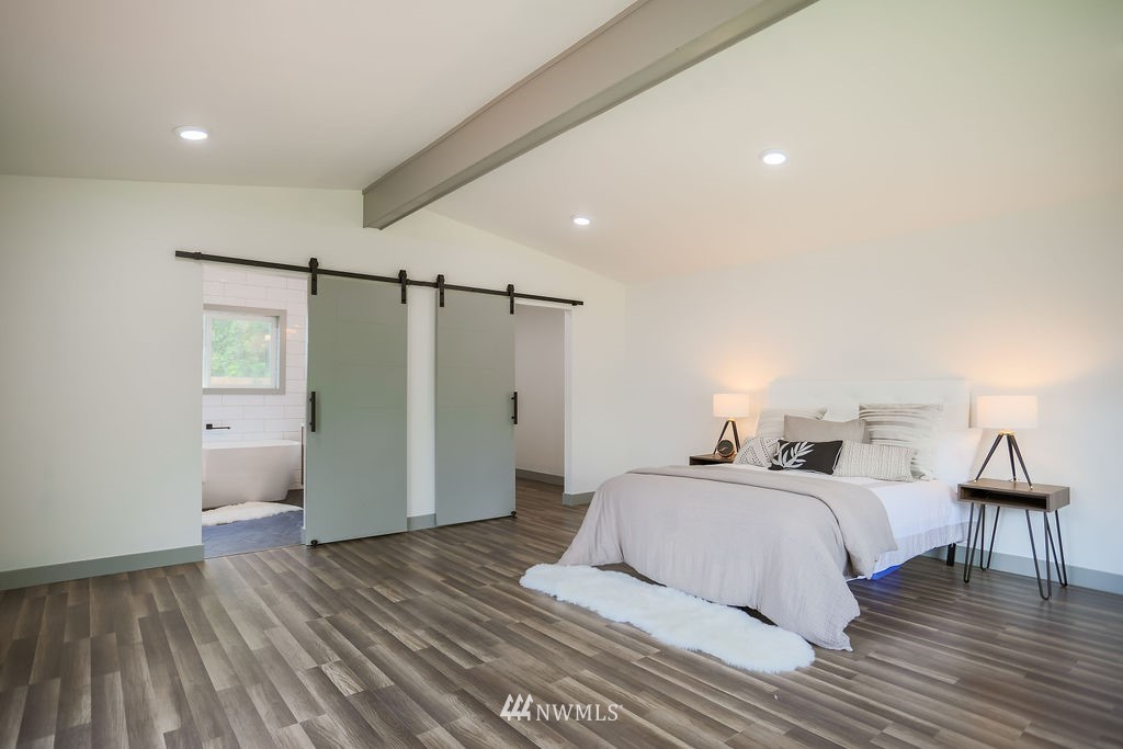 10910 Southeast 181st Street Renton, WA 98055 - Photo 27 of 32 a bedroom with a bed and wooden floor