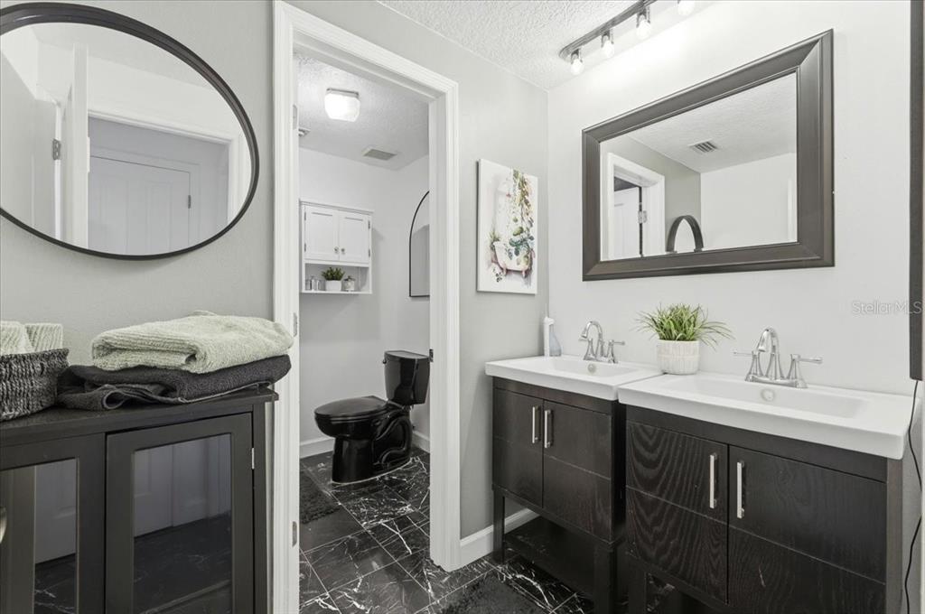 4703 Rambling River Road Brandon, FL 33511 - Photo 26 of 62 a bathroom with a toilet a sink and mirror