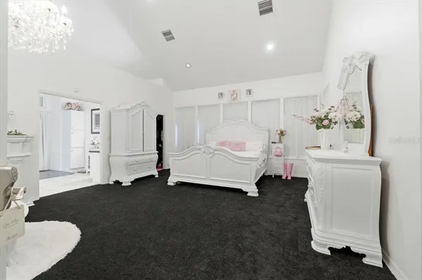 a spacious bedroom with a bed and a window