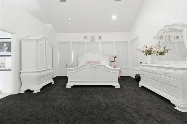 a living room with furniture a fireplace and a chandelier