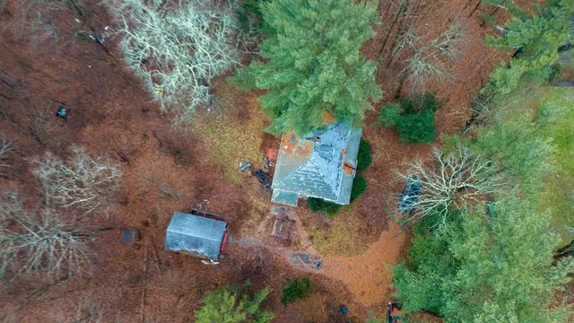 an aerial view of a house with a yard