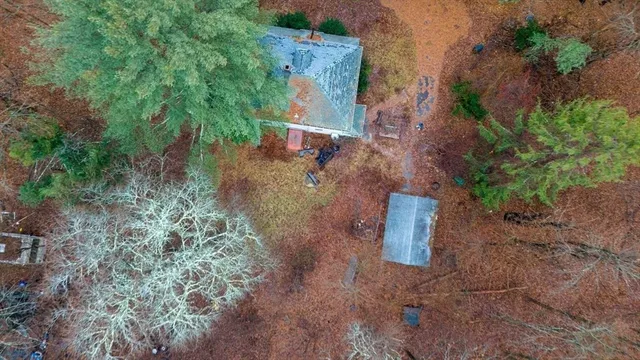 an aerial view of a house with a yard