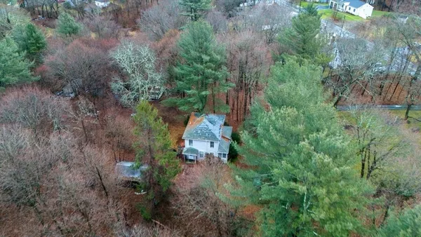 an aerial view of a house with a yard