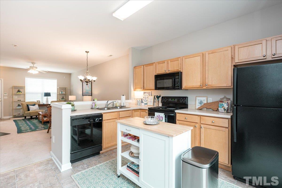1707 Grace Brook Road Raleigh, NC 27609 - Photo 8 of 17 a kitchen with a sink a stove and refrigerator