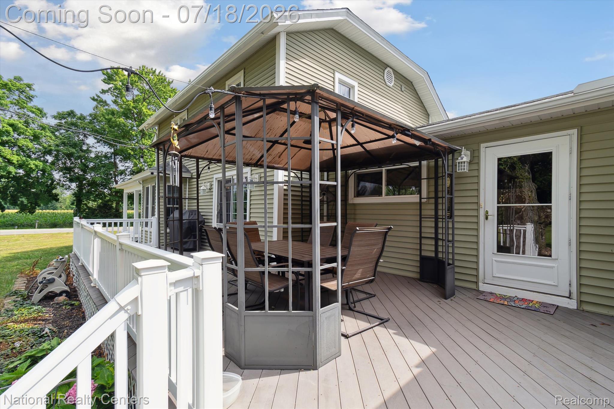 9589 Clinton Macon Road Tecumseh, MI 49286 - Photo 37 of 48 Spacious outdoor deck featuring a gazebo, white railing, and exterior wall siding