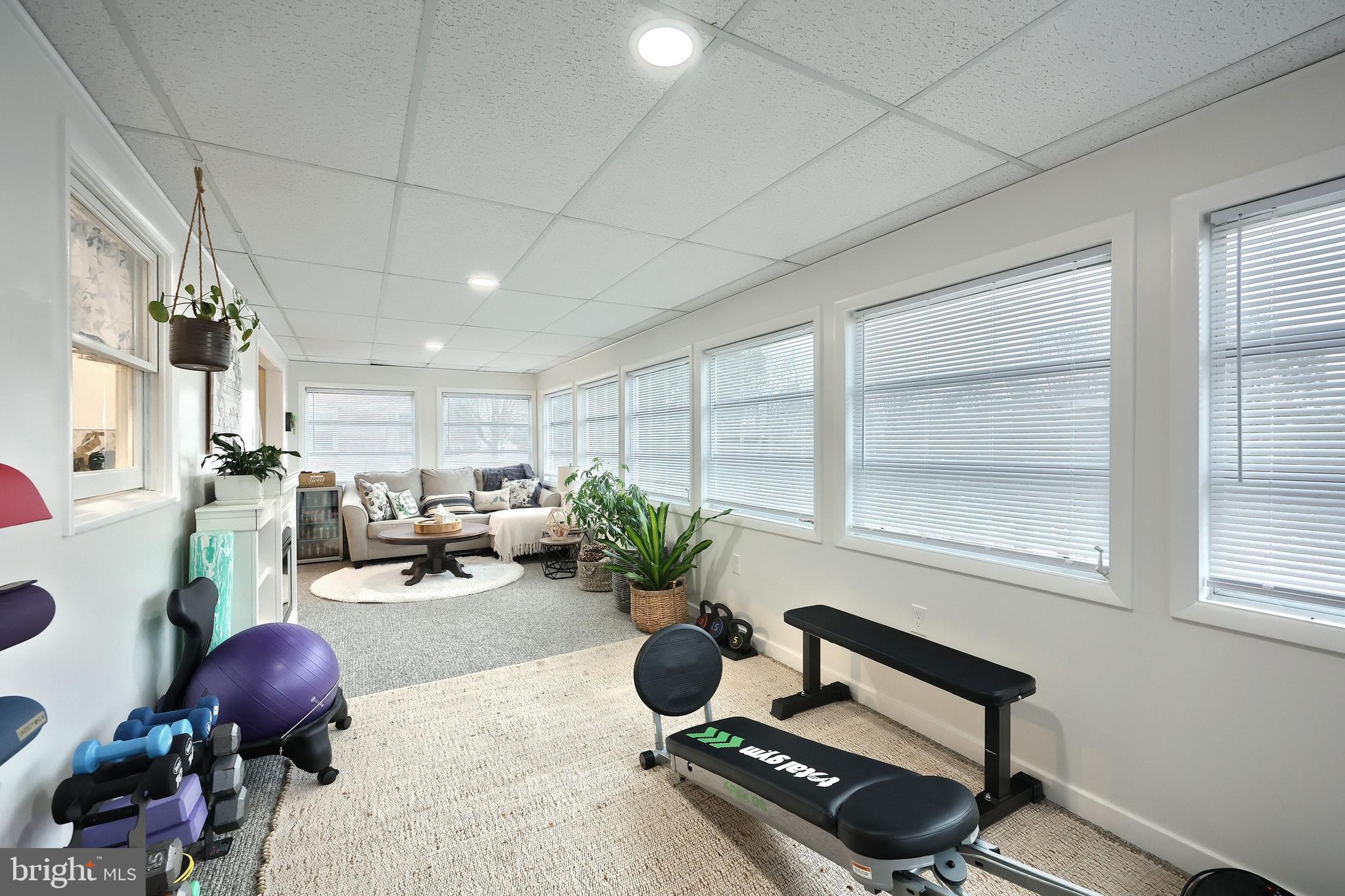 56 York Road York, PA 17407 - Photo 16 of 45 a living room with furniture gym equipment and a large window
