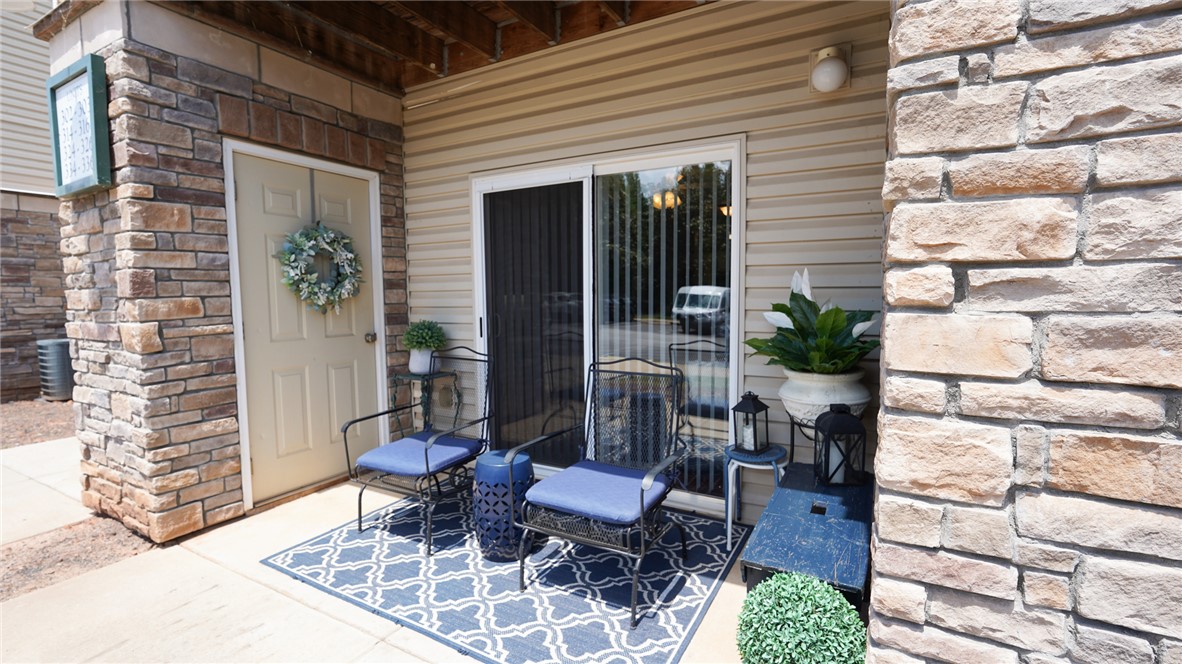303 Lookover Drive Anderson, SC 29621 - Photo 4 of 46 This inviting patio area features a cozy seating arrangement, perfect for relaxation or intimate gatherings.