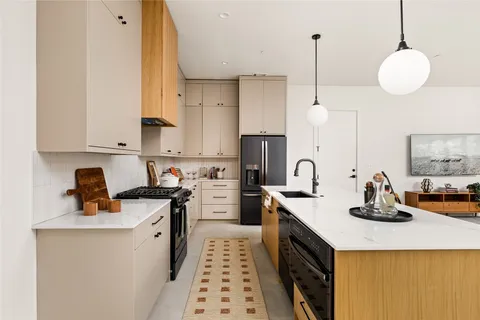 a kitchen with a sink a stove and cabinets