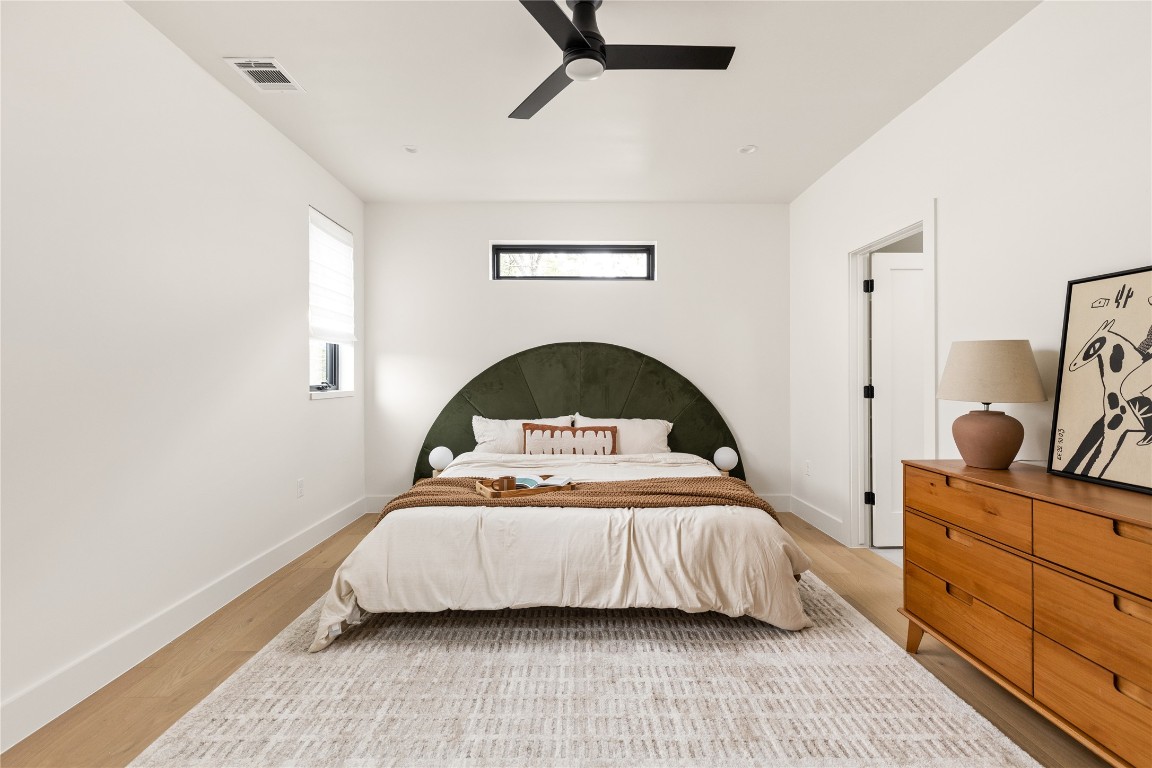 4416 South 1st Street, Unit 2 Austin, TX 78745 - Photo 19 of 40 Bedroom featuring light wood-style flooring and a ceiling fan