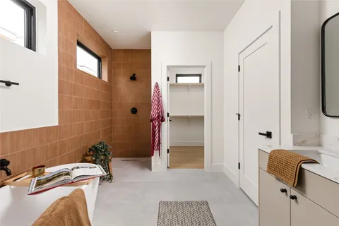 a bathroom with a bathtub and shower