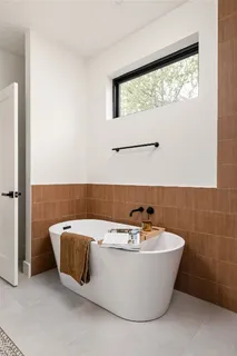 a bathroom with a bathtub and window
