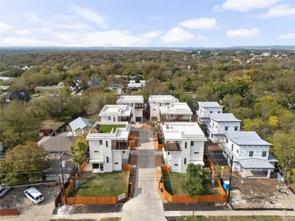 an aerial view of residential houses with city view