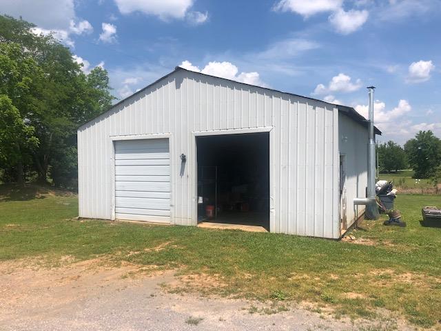 450 Sims Spring Road Shelbyville, TN 37160 - Photo 6 of 29 Clean detached garage with concrete floor and power