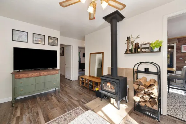 a living room with furniture a flat screen tv and a fireplace