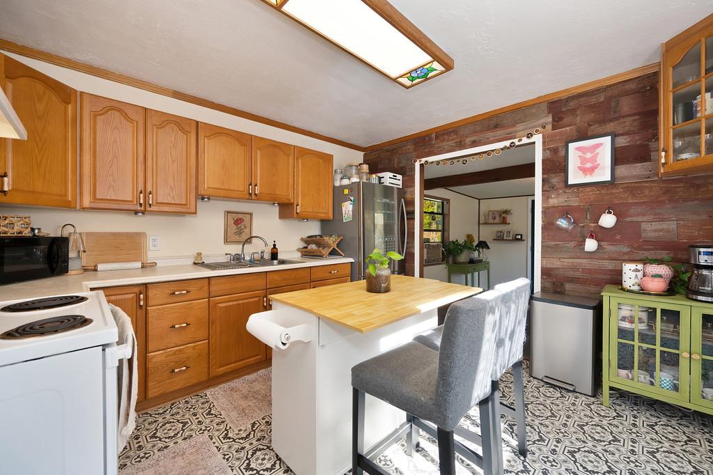 128 Main Street Gold Run, CA 95717 - Photo 13 of 44 a kitchen with stainless steel appliances granite countertop a stove a sink and a refrigerator