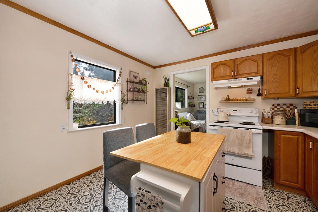 128 Main Street Gold Run, CA 95717 - Photo 15 of 44 a kitchen with a table chairs and wooden floor