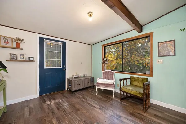a view of a livingroom with furniture and workspace