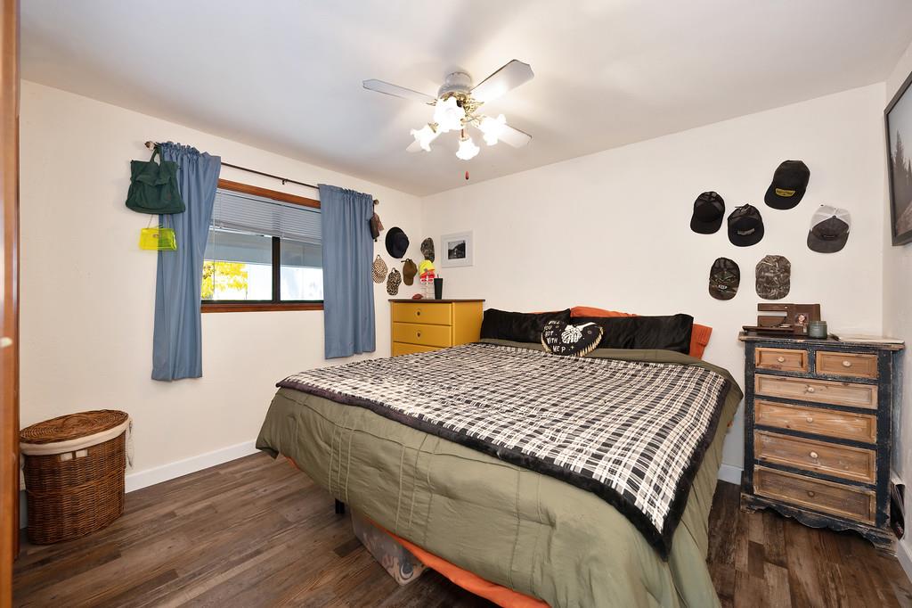 128 Main Street Gold Run, CA 95717 - Photo 20 of 44 a bedroom with a bed and wooden floor