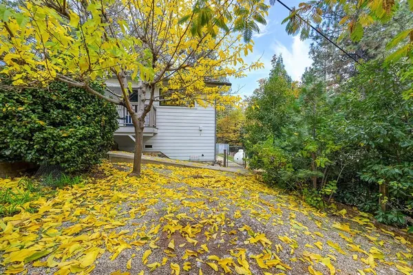 a yellow house with trees in front of it
