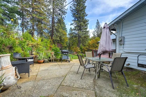 a view of a backyard with sitting area