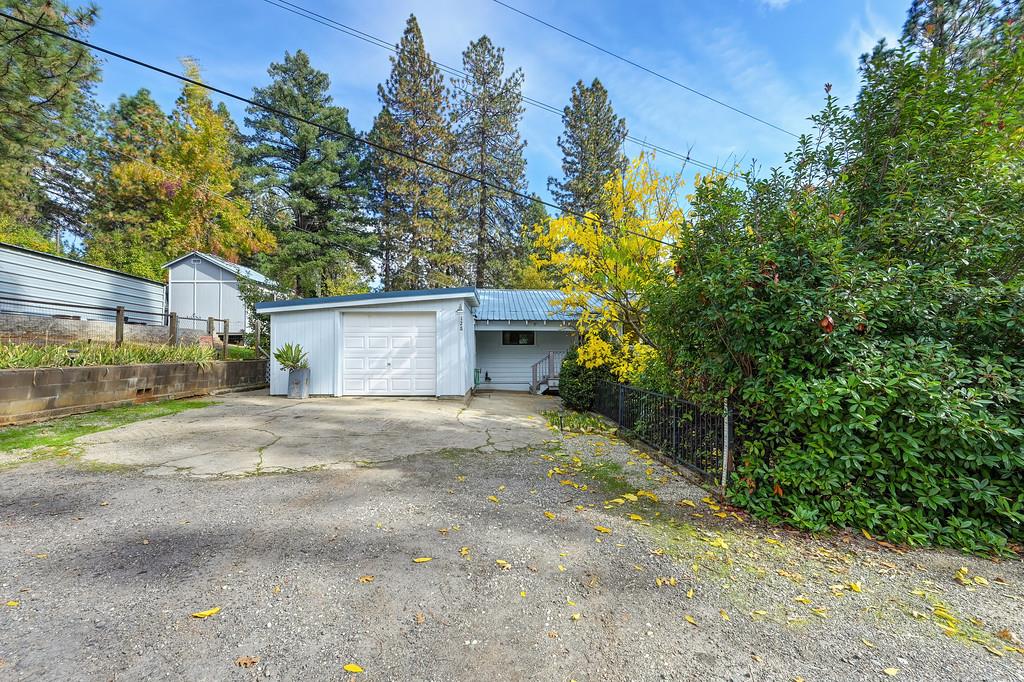 128 Main Street Gold Run, CA 95717 - Photo 5 of 44 a front view of a house with a yard and garage