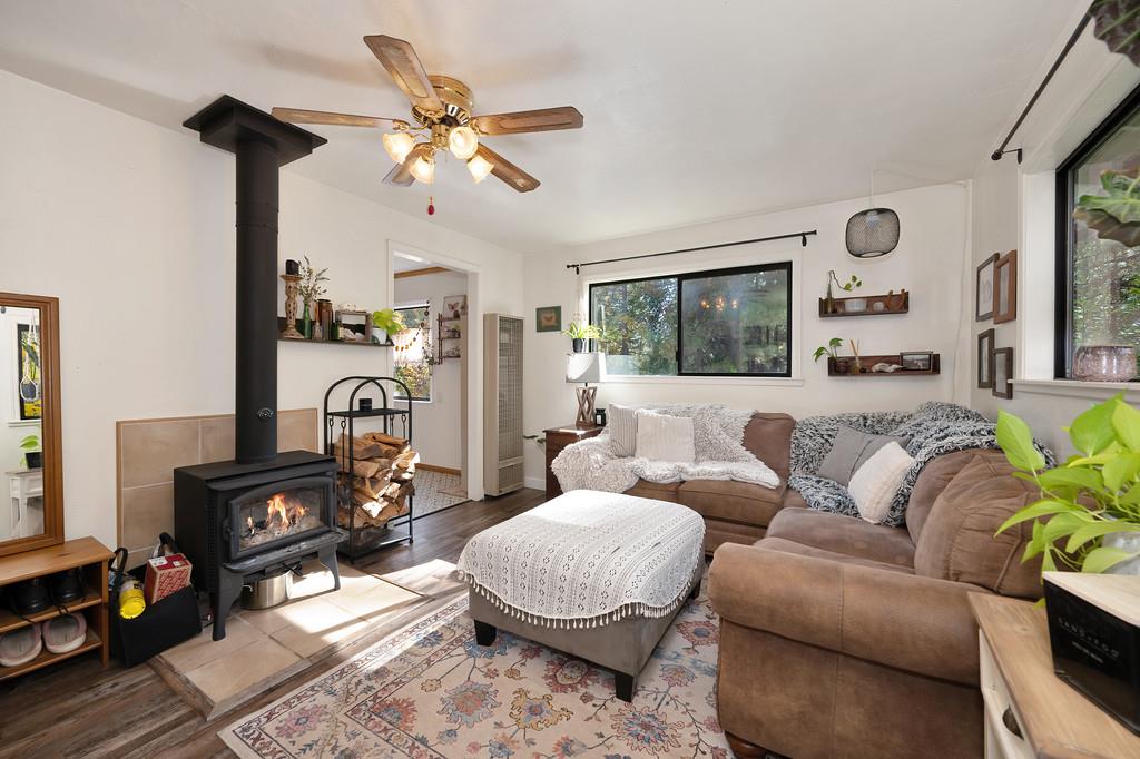 128 Main Street Gold Run, CA 95717 - Photo 9 of 44 a living room with furniture a fireplace and a window