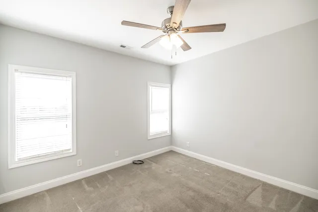 a view of a kitchen with a sink and a refrigerator