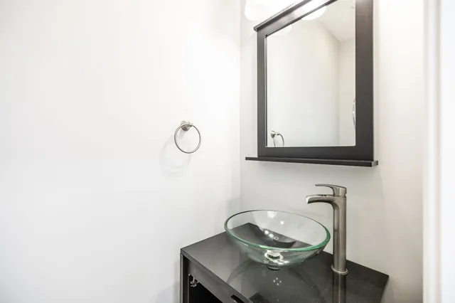 a view of an empty room with wooden floor fireplace and a window