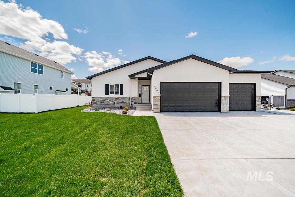 2097 Magellan Loop Pocatello, ID 83204 - Photo 1 of 1 Contemporary exterior featuring white stucco, a two-car garage, a one-car garage, and stone accents