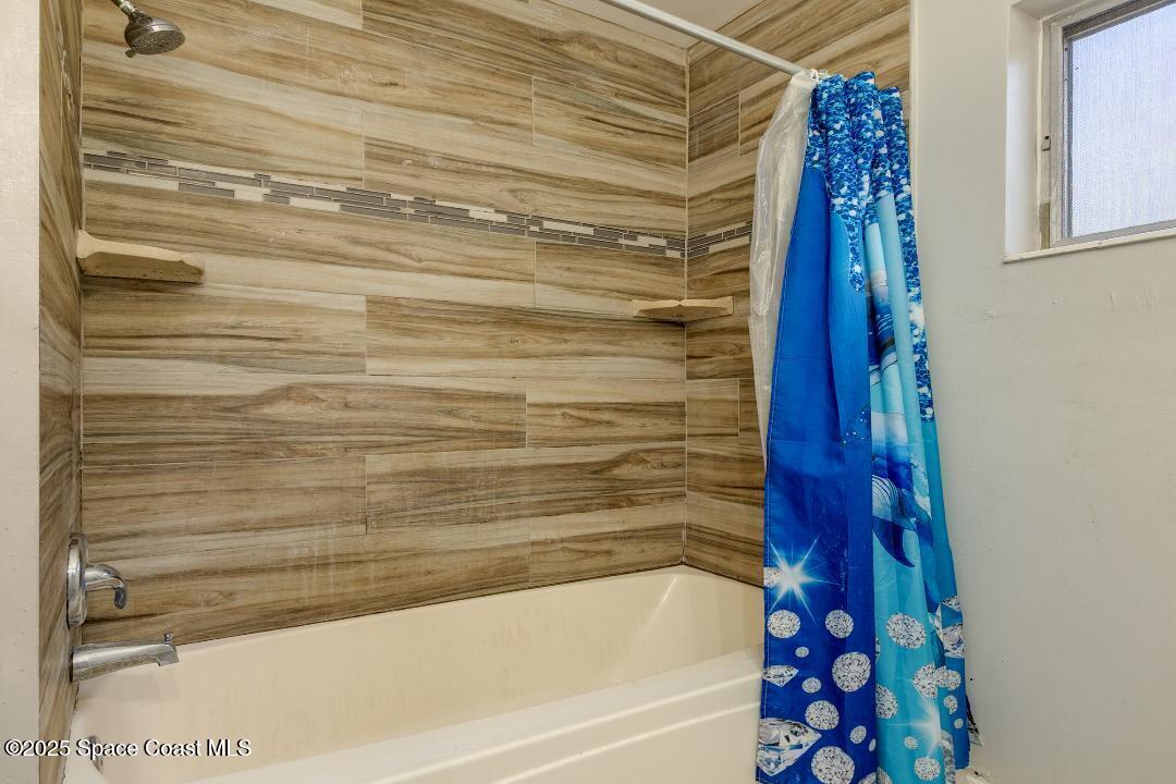 2465 Sarno Road Melbourne, FL 32935 - Photo 17 of 24 a bathroom with bathtub and shower