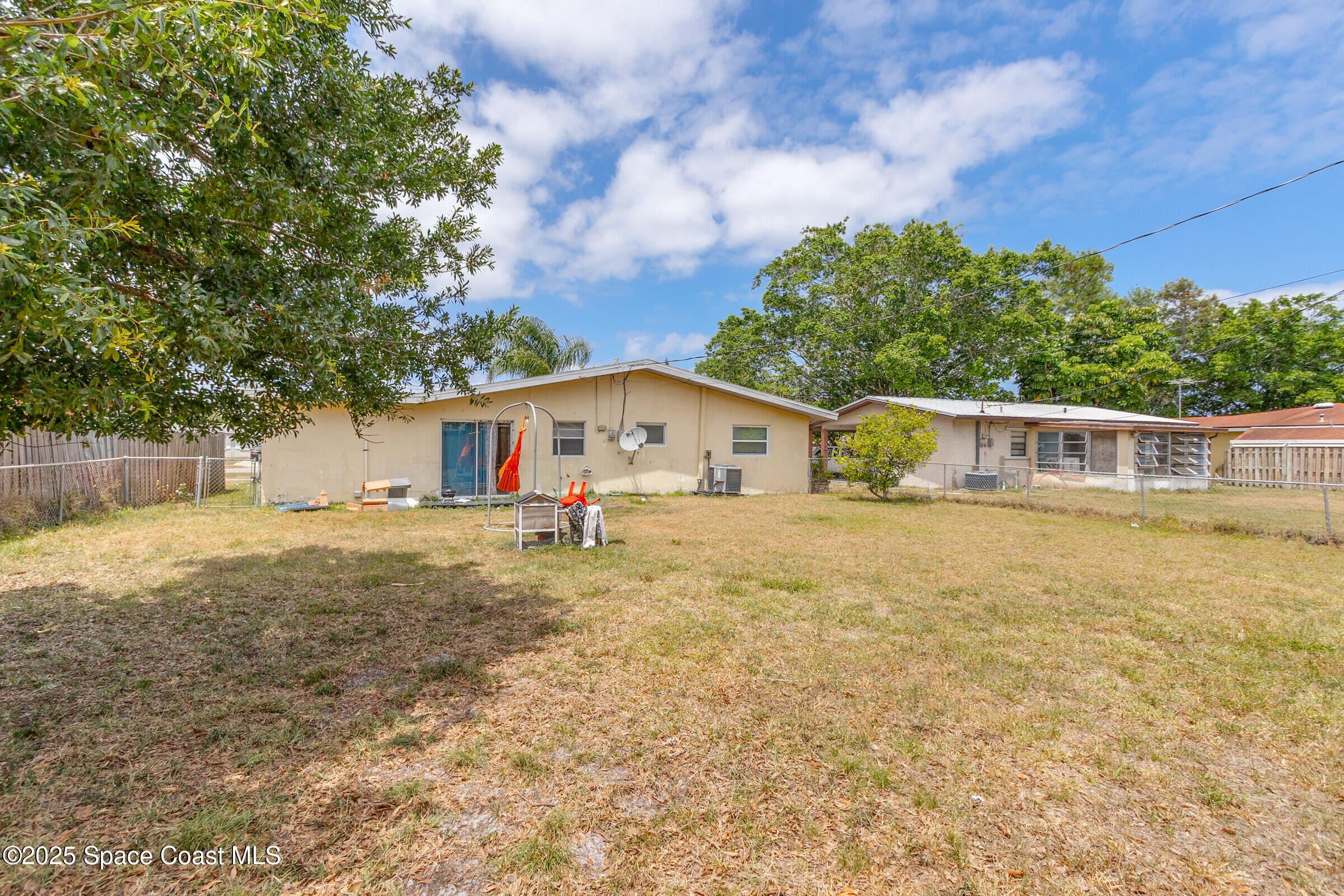 2465 Sarno Road Melbourne, FL 32935 - Photo 23 of 24 a front view of house with yard and trees in the background