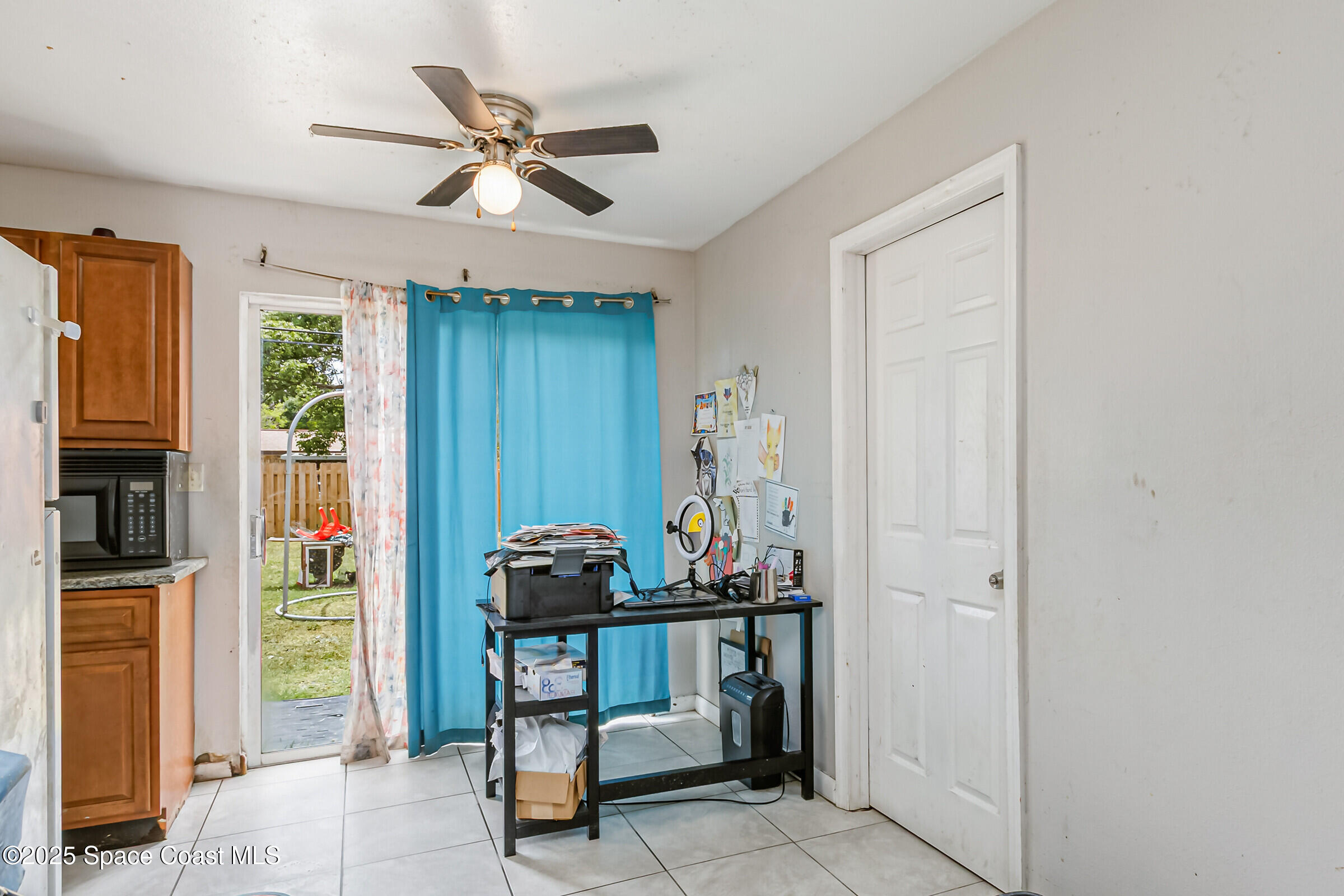 2465 Sarno Road Melbourne, FL 32935 - Photo 8 of 24 a room with chandelier fan and windows