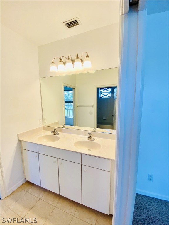 12914 Timber Ridge Drive Fort Myers, FL 33913 - Photo 12 of 21 a bathroom with a double vanity sink and mirror
