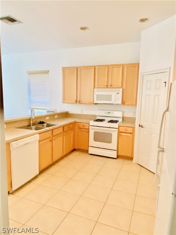 12914 Timber Ridge Drive Fort Myers, FL 33913 - Photo 17 of 21 a kitchen with a stove a sink dishwasher and white cabinets with wooden floor