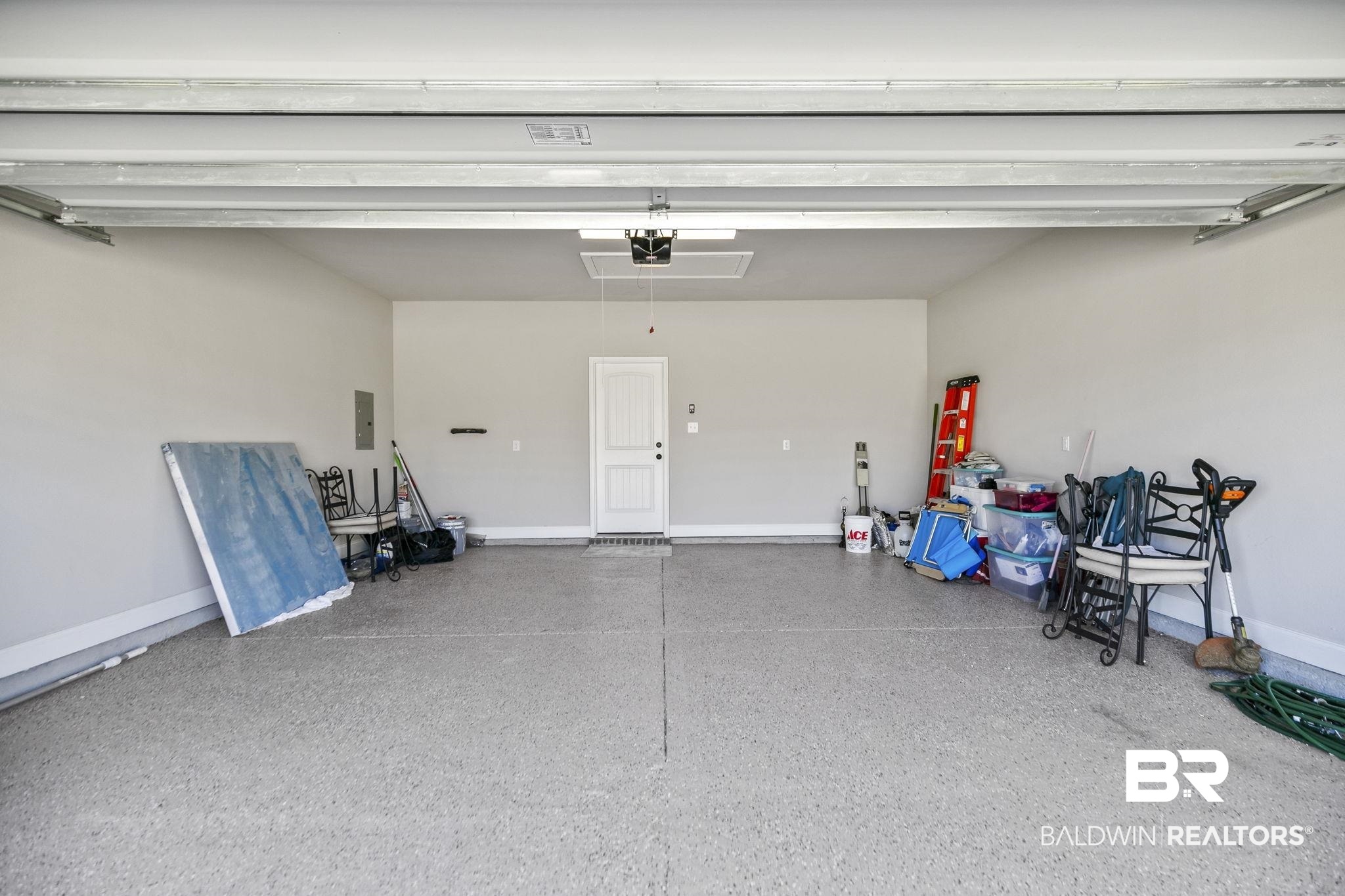 10140 Chipper Lane Foley, AL 36535 - Photo 42 of 72 Garage featuring a garage door opener and electric panel