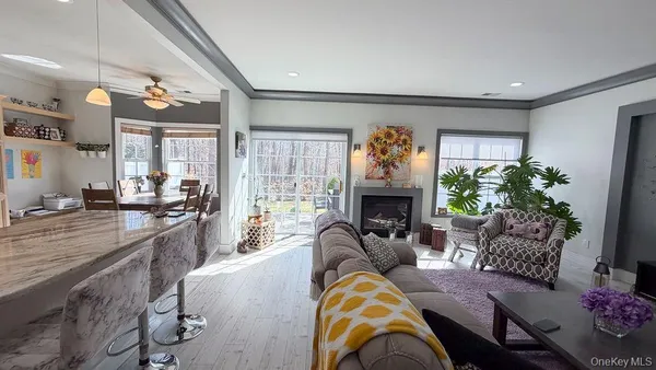 a living room with furniture fireplace and a potted plant