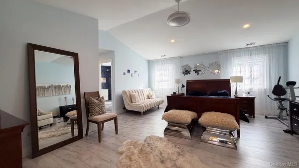 a bedroom with furniture and a window