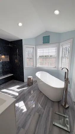a spacious bathroom with a bathtub and a window