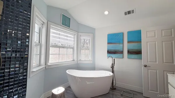 a spacious bathroom with a granite countertop sink and a mirror